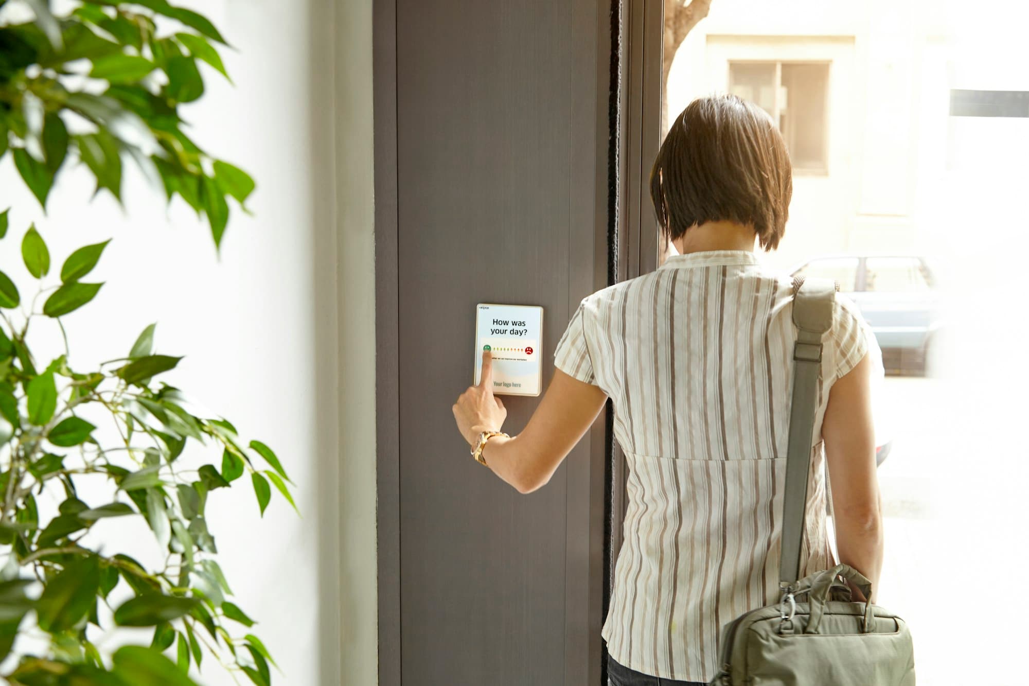 Employee tapping an access badge on a door reader