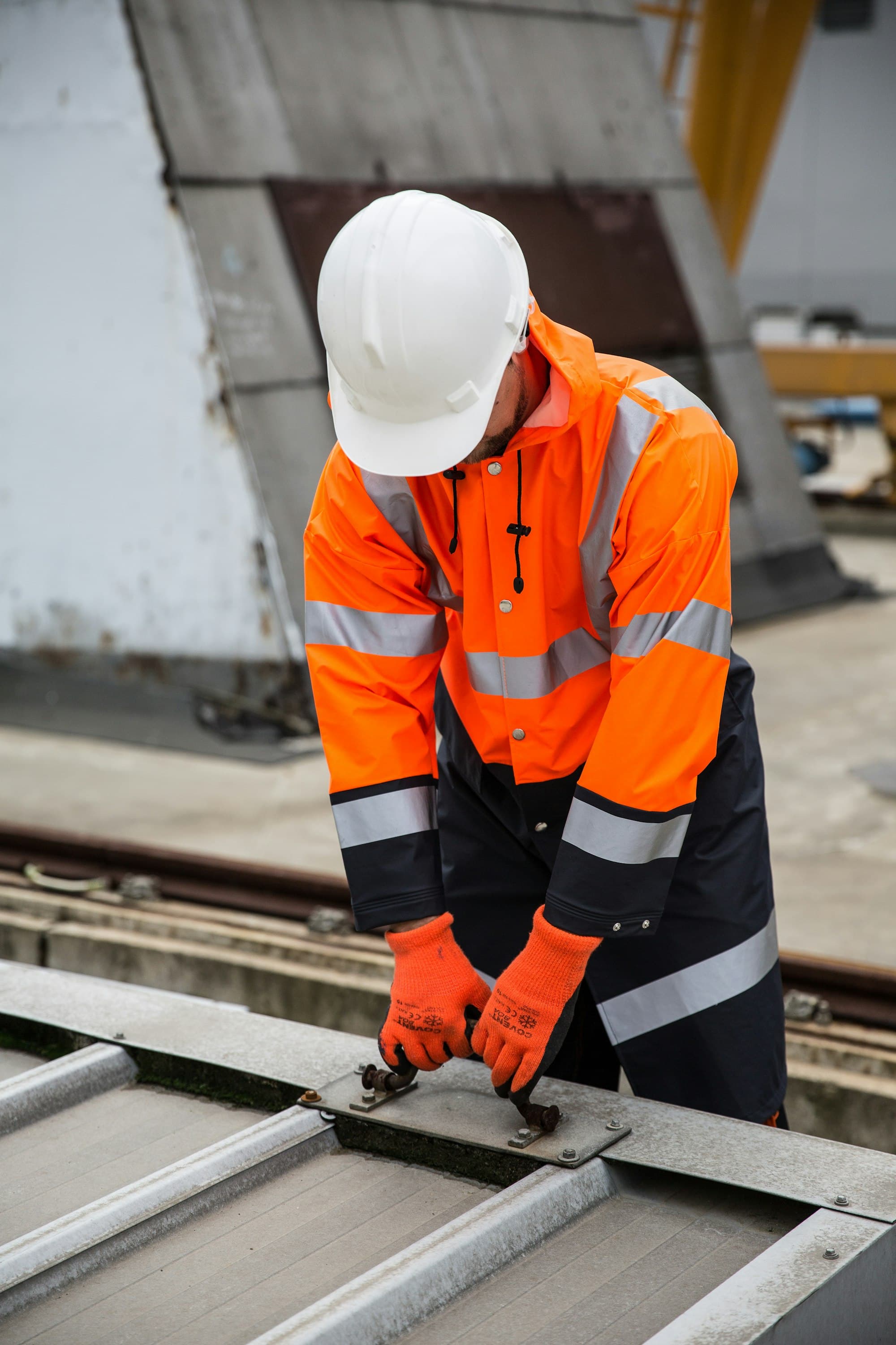 Contractor in a high-visibility jacket working on site