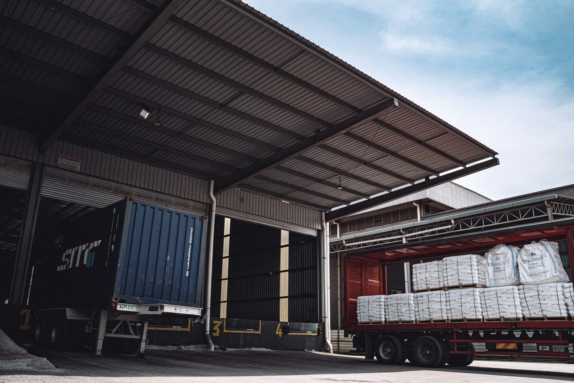 Delivery trucks unloading at a warehouse dock